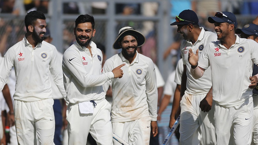 India's captain Virat Kohli, second from left, carries a wicket as he celebrates with his team players after their win over England on the fifth day of the fourth cricket test match between India and England in Mumbai, India, Monday, Dec. 12, 2016. (AP Photo/Rafiq Maqbool)